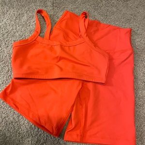 Thirty years hi-fit biker shorts and all body bralette set in poppy. Size small